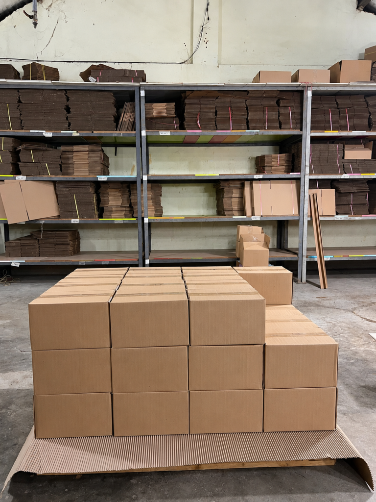 Corrugated cardboard boxes and packaging materials stored at Truc Lam's manufacturing facility in Vietnam.